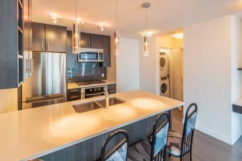 Modern, bright, clean kitchen interior with stainless steel appliances in a l Stock Photos