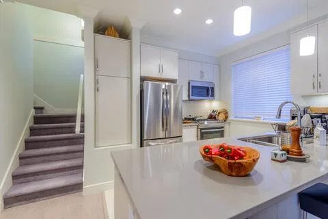 Modern, bright, clean, kitchen interior with stainless steel appliances in a  Stock Photos