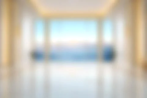 Modern bright living room with large windows, minimal decor, polished floor.. Stock Photos