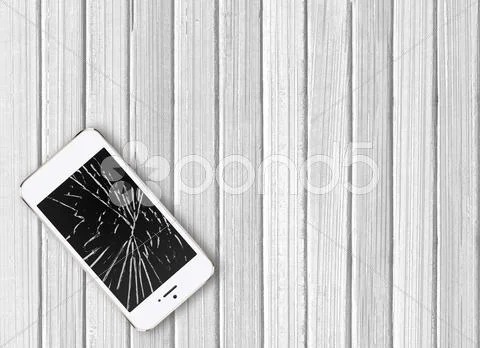 Modern Broken Mobile Phone On White Wooden Background