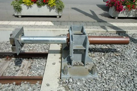 Modern buffer stop at the end of railway tracks on railway station. Stock Photos