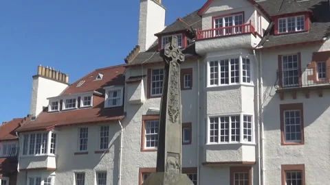 A modern building and an old celtic cross Stock-Footage 91142879