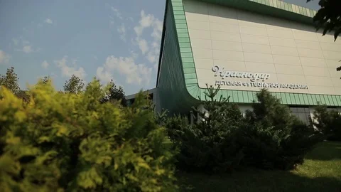 Modern building and a park area in from of it, m/s Stock Footage 75986317