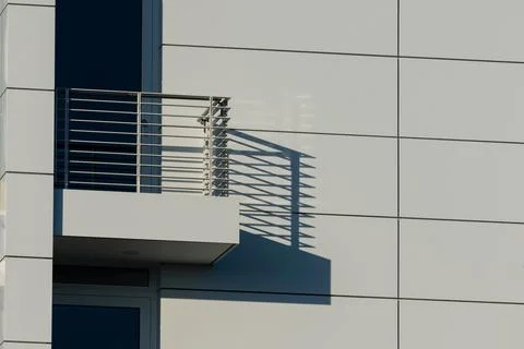 Modern building architecture showcasing shadow patterns on wall Stock Photos
