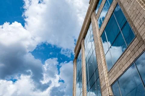 Modern building on a background of clouds Stock Photos