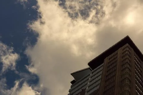 A modern building below a cloudy sky Stock Photos