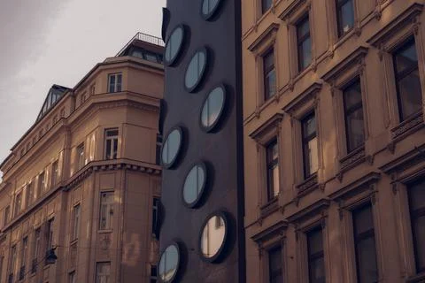 Modern building between two old buildings Stock Photos