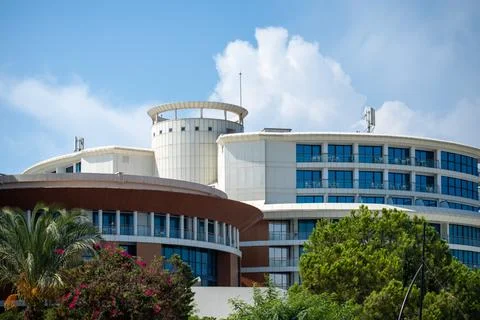 Modern Building Complex Exterior with Trees and Cloudy Sky Stock Photos