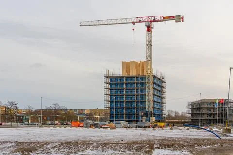 Modern building construction with tower crane and blue facade panels Stock Photos