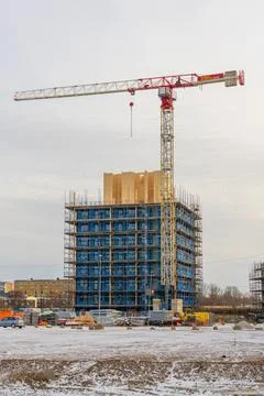 Modern building construction with tower crane and blue facade panels Stock Photos