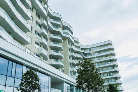 Modern building design shows multiple balconies in a residential area under.. 写真素材