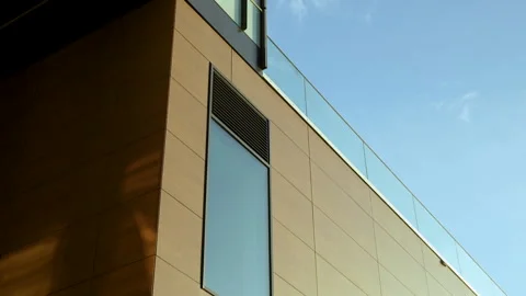 Modern Building Exterior With Wall Cladding Panels. low angle, tilt-down Stock Footage 258225554
