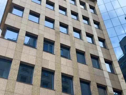 Modern building facade with blue window pattern and geometric symmetry. Abs.. Stock Photos