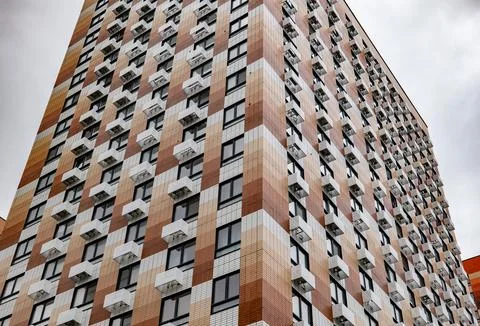Modern building facade with checkerboard pattern, many windows and air Stock Photos