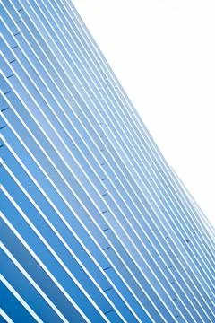 Modern building facade featuring abstract blue and white parallel lines 库存照片