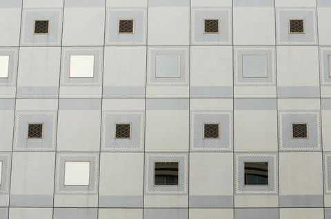Modern building facade with geometric pattern and reflective windows 스톡 사진