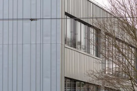Modern building facade with large windows and metal panels in a clean minimal Stock Photos