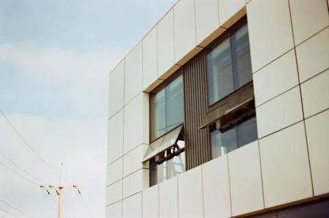 Modern building facade with open windows and clean lines Foto stock