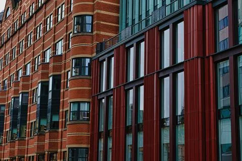 Modern building facade with a pattern of red and brown rectangular windows .. Stock Photos