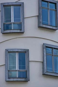 Modern building facade with square windows and blue reflections Stock Photos