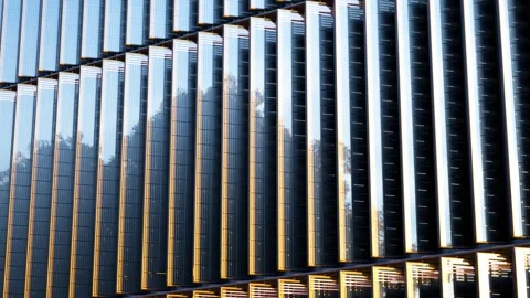 Modern building facade with vertical moving solar panels tracking sunlight Stock Footage 288978671