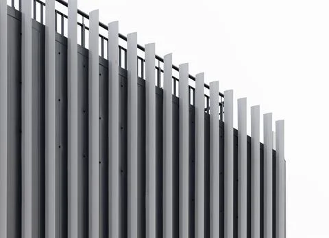 Modern building facade with vertical slats against a bright sky. Abstract Stockfoto's