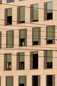 Modern building facade with windows and power lines Stock Photos