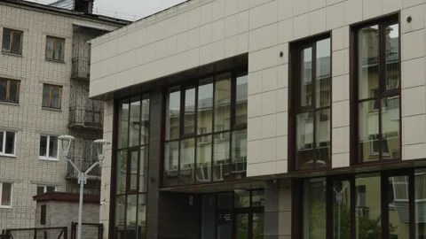 Modern building with glass windows reflecting the city street Stock Footage 335472071