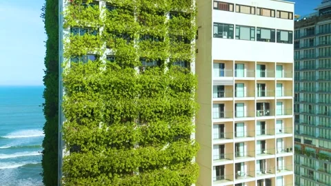 Modern building with a green wall promoting sustainability and eco friendly Vídeos de archivo 302733301