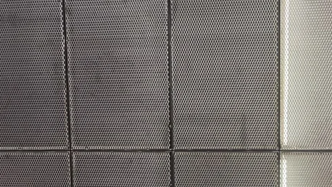 Modern building interior design featuring metal mesh panels and integrated Vidéo 315359658