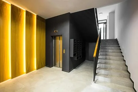 Modern building interior with elevator and staircase design Stock Photos
