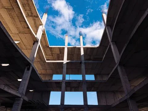 Modern building interior with large open ceiling and sky view Stock Photos
