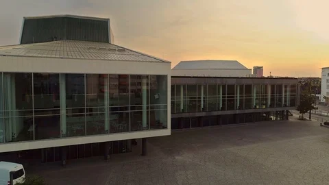 Modern Building with Large Windows and Sunset in the Background / Pfalzbau Ludwi Stock Footage 120560542