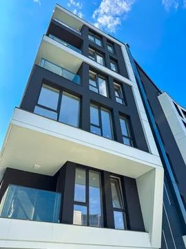 Modern building with large windows on a clear day in an urban area Stock Photos