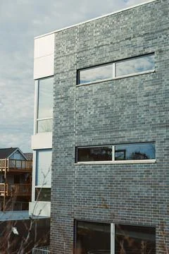 Modern building with large windows located in an urban area, showcasing a m.. Stock Photos