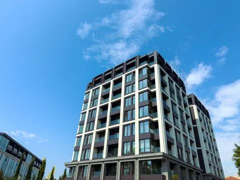 Modern building with large windows under a clear sky in an urban area Stock Photos