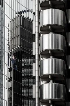 Modern building with metal cladding, reflecting the facade of an adjacent Stock Photos