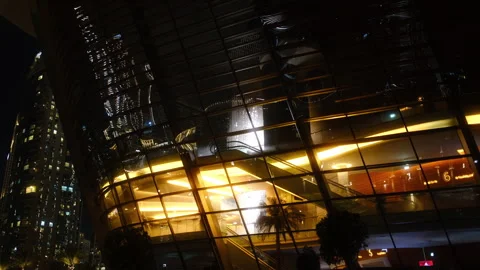 A modern building at night, glowing windows highlight its design Stock Footage 307935179