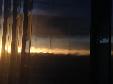 Modern building reflecting sunset Stock Photos