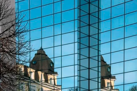 Modern building with reflections in the windows. Stock Photos