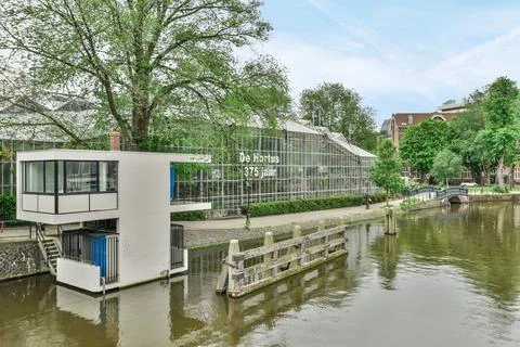 A modern building with a river in front of it Stock Photos