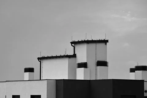 Modern building rooftops against cloudy sky Stock Photos