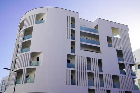 Modern building rounded facade with balcony and terrace on sunny day with a b Fotos de archivo