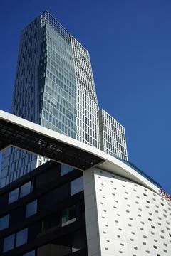 A modern building with a sky background and an attached walkway Fotos de archivo