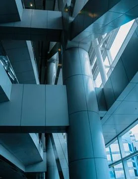 Modern building's interior with large windows and blue glass panels Stock Photos