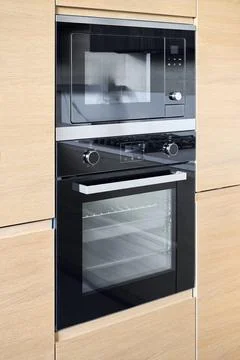 Modern built-in kitchen appliance set microwave or combi oven on top with ful 스톡 사진