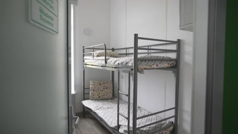 Modern bunk bed nightstands with linen and pillows in dorm Stock Footage 314655899