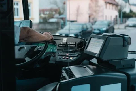 Modern bus interior with drivers hand Stock Photos