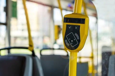 Modern Bus Interior with Payment Terminal and Yellow Grab Handle Photos
