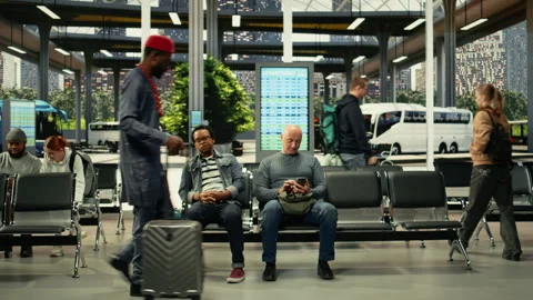 Modern bus station hall with diverse travelers sitting in waiting area Stock Footage 334726690